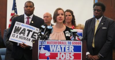 Food & Water Watch expert Mary Grant speaks at a podium with other leaders at a media event in Atlantic City.